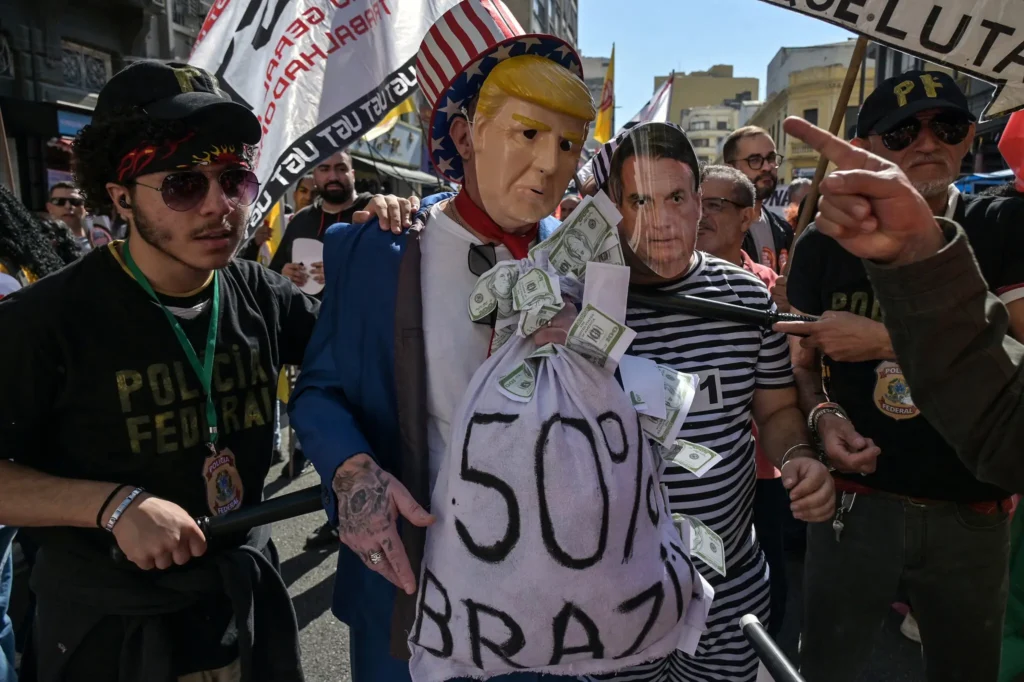 Protesters wearing masks depicting President Trump and Mr. Bolsonaro at a protest in Sao Paulo, Brazil, on Friday.Credit...