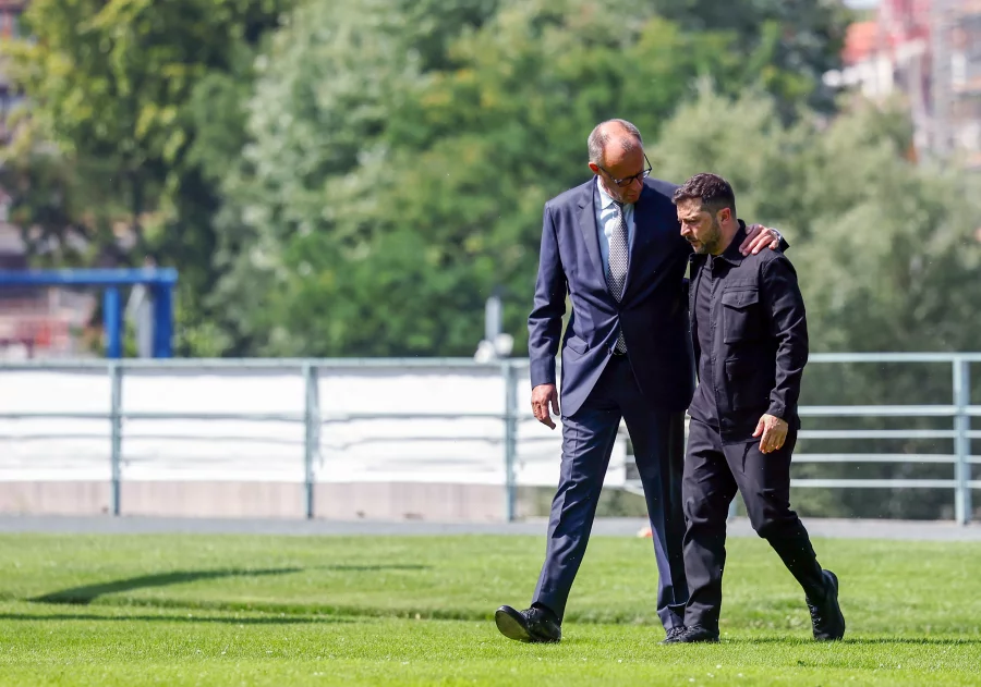 a man in suit walking with another man in suit